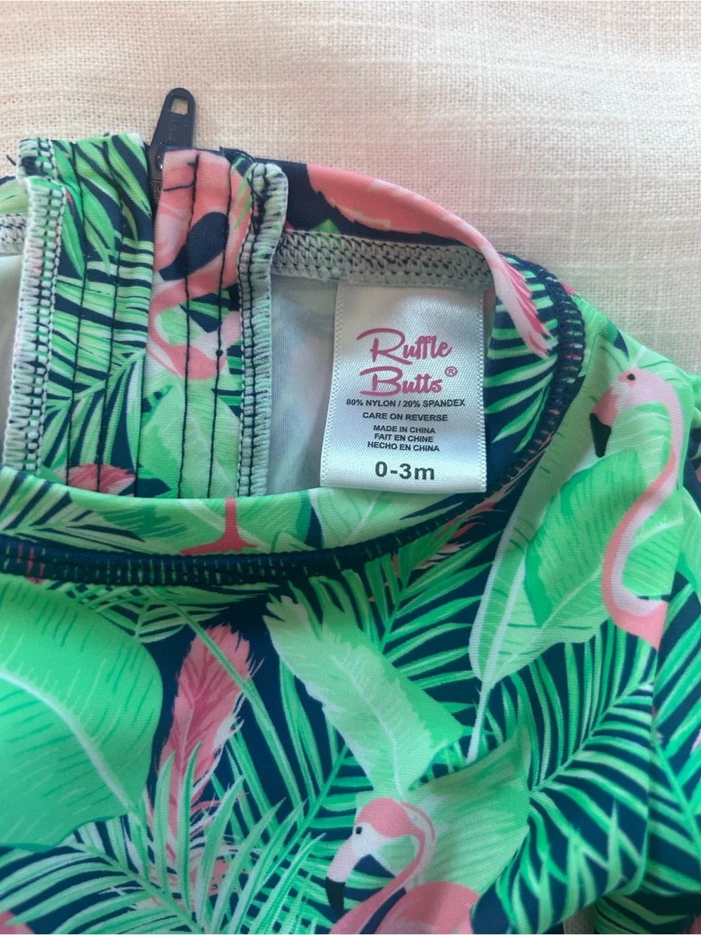 Ruffle Butts Navy One-Piece Swim with Pink Flamingo & Green Leaves
